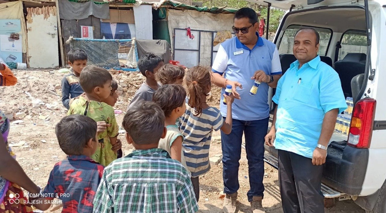Volunteers distributing milk to children