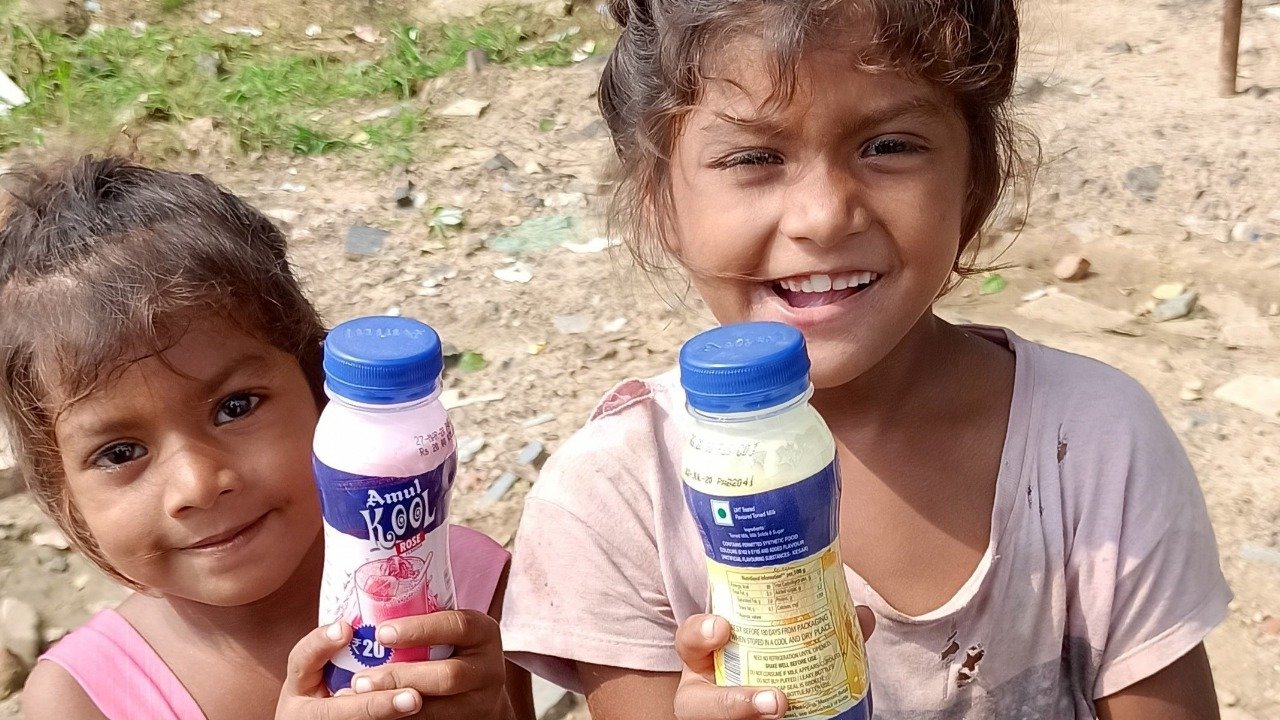 Happy children with Amul milk bottles